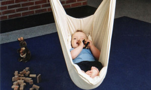 Baby spielt in der Federwiege